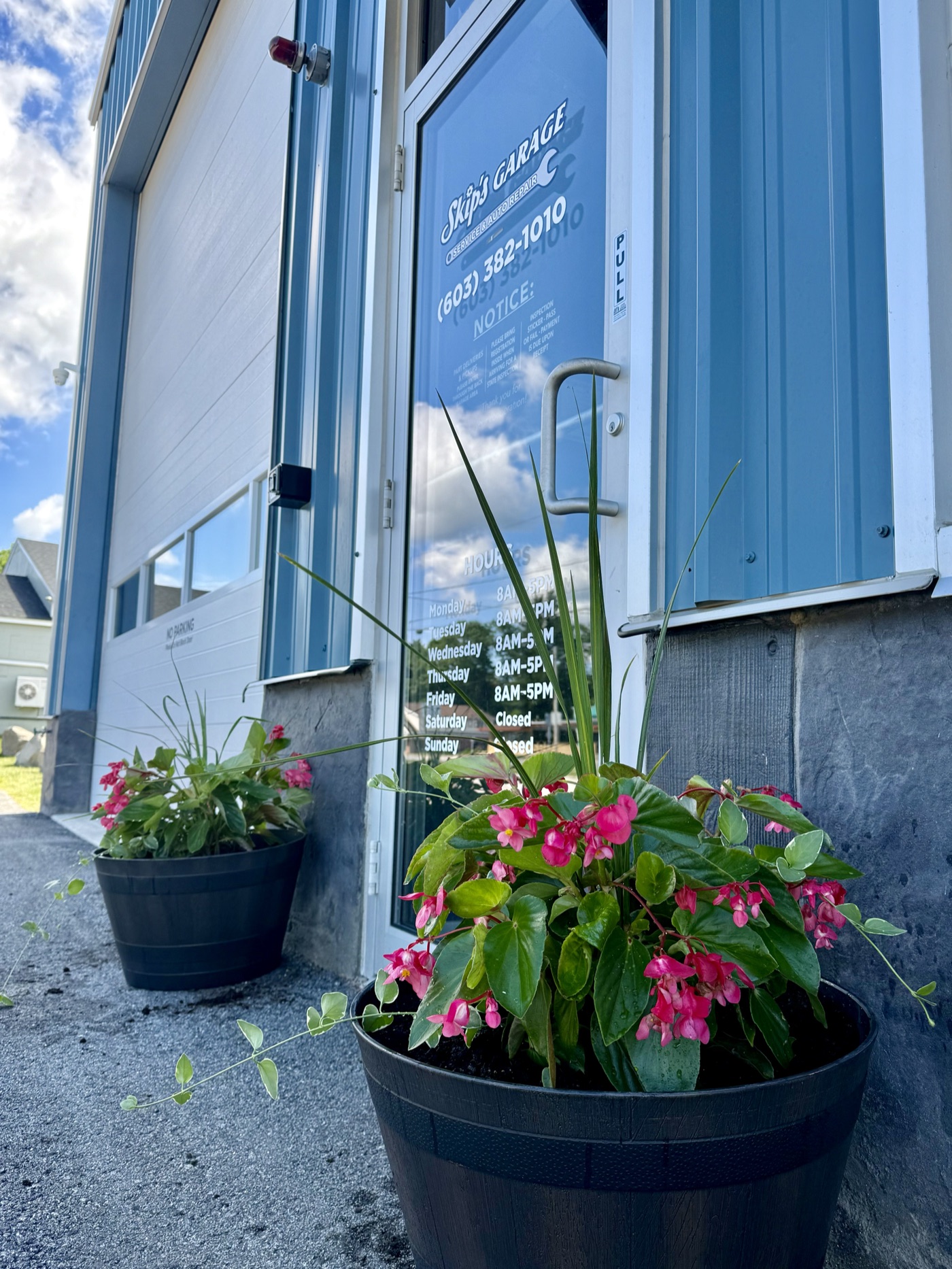 Skip's Garage front entrance with seasonal flowers