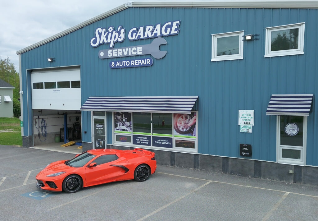 Skip's Garage exterior with a sports car parked outside