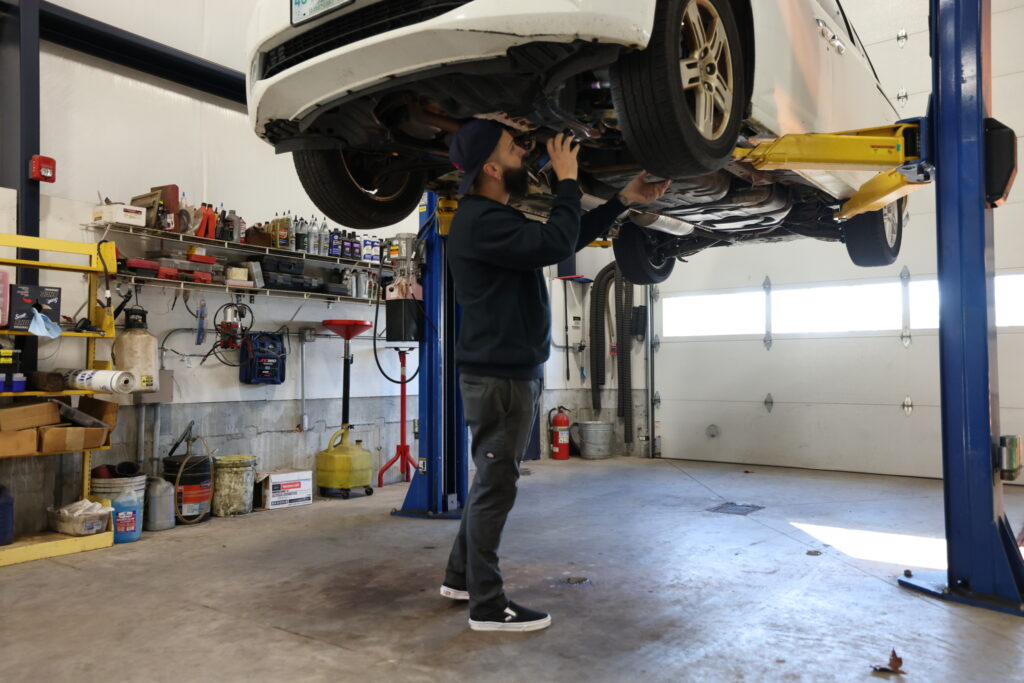 Mechanic checkin the suspension at Skip's Garage